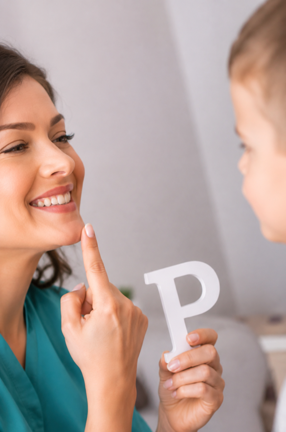 A therapist and child practicing speech sounds with a letter P